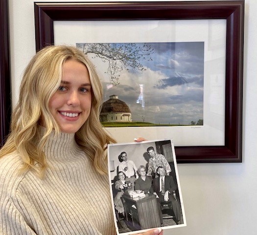 UIF student worker Ava Oros holds a photo of her grandfather, U of I graduate Bill Whitfield